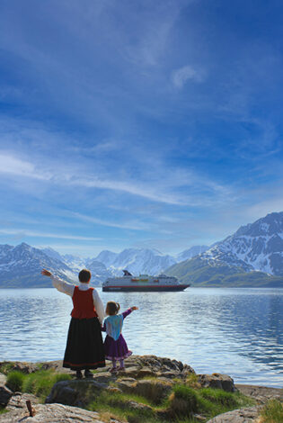 Two generations of Norwegians waving at the Hurtigruta